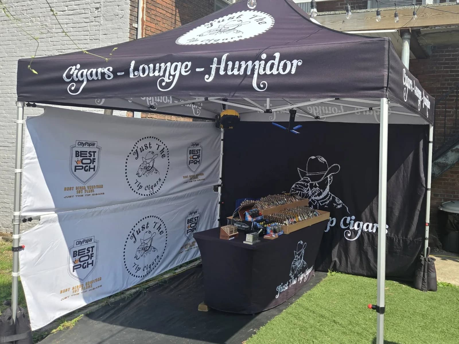Tent and humidor table set up on a patio